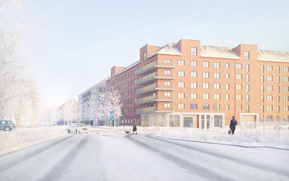 En väg med cirkulationsplats, bilar och människor samt ett stort flerbostadshus i vinkel bakom.